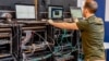 A man works next to servers specialised in cyber security 